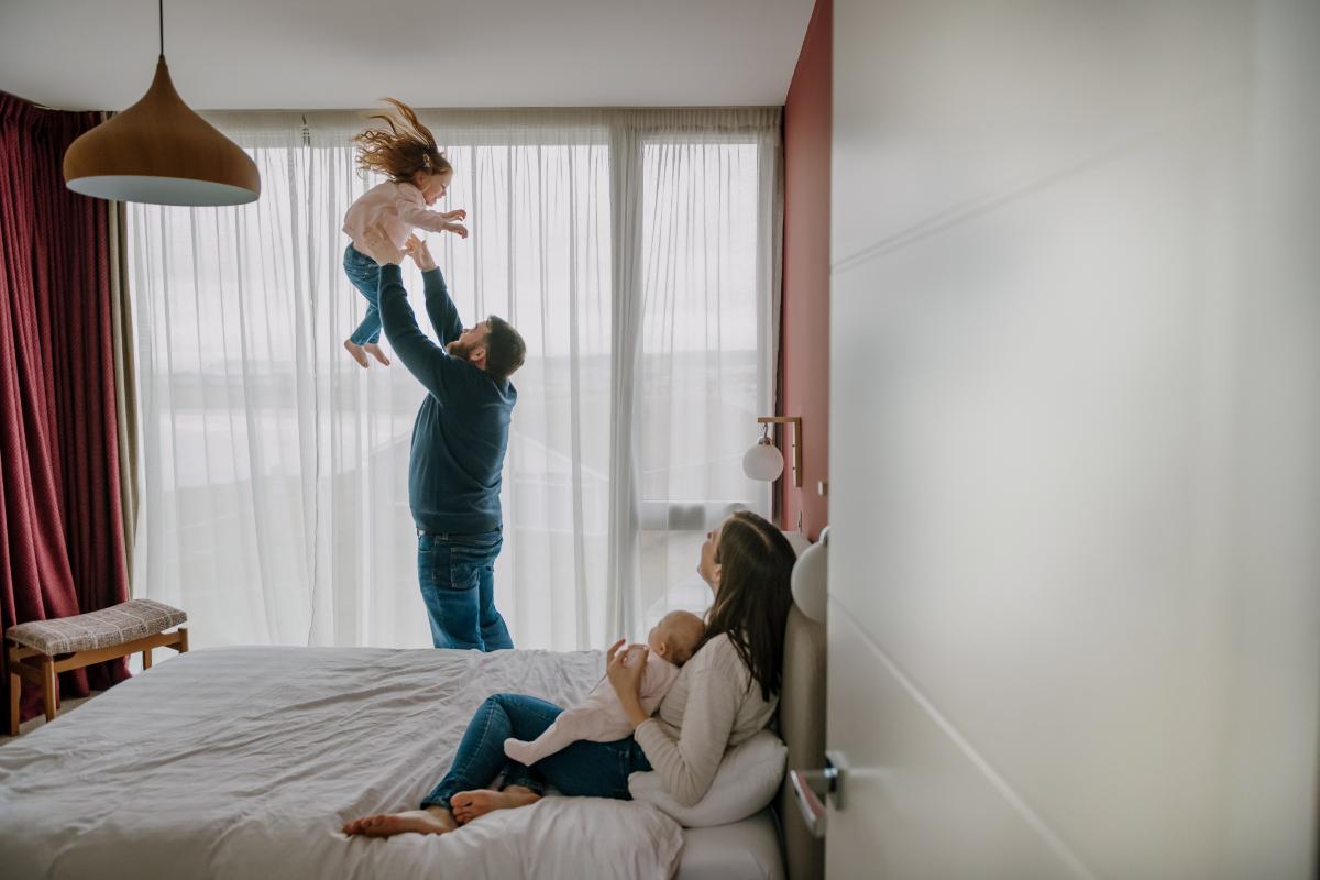 Dad throwing little girl up into the air
